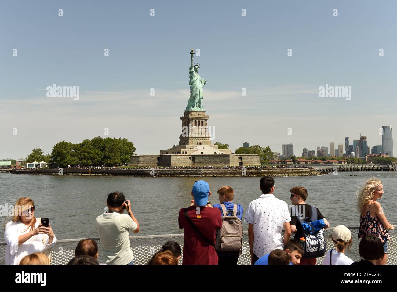 New York, USA - June 09, 2018: Passengers of the Ferry of Statue Cruises see and make a pictures of the Statue of Liberty. Stock Photo