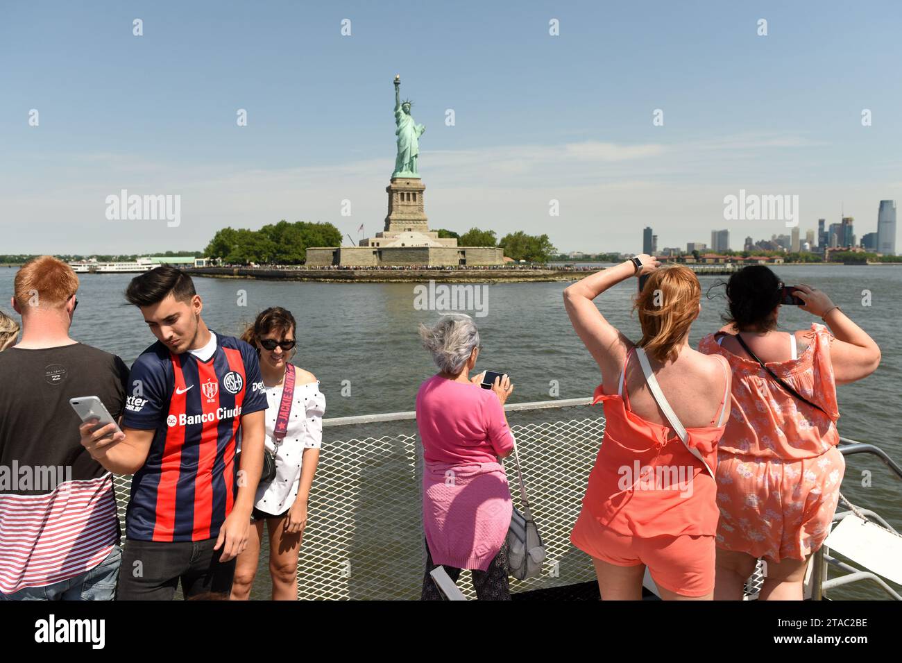 New York, USA - June 09, 2018: Passengers of the Ferry of Statue Cruises see and make a pictures of the Statue of Liberty. Stock Photo