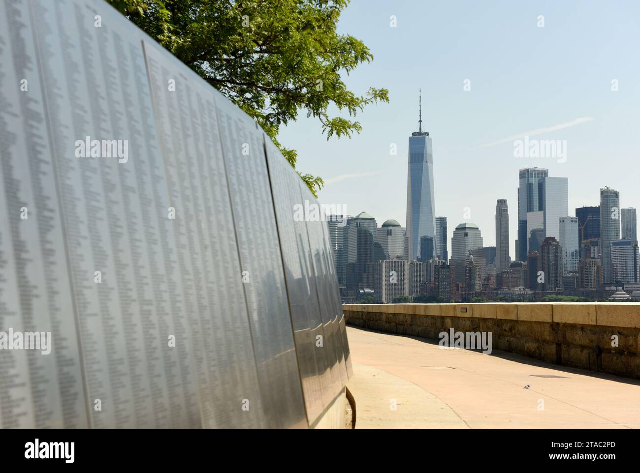 New York, USA - June 09, 2018: The American Immigrant Wall of Honor is located at the Ellis Island National Museum overlooks the Lower Manhattan skyli Stock Photo