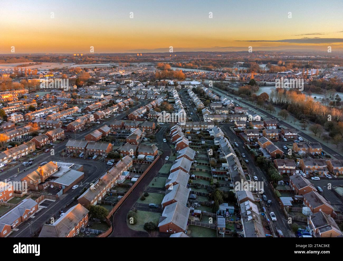 The sun rises over houses in Lee Park, Liverpool Merseyside. Road users