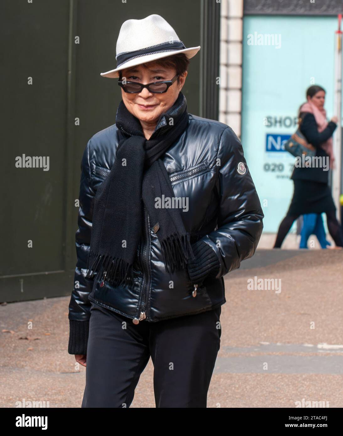 Who's that girl?   Yoko Ono - spotted walking in Green Park area today unnoticed by crowd enjoyed the spring sunshine. 17.3.10  She wore white panama Stock Photo