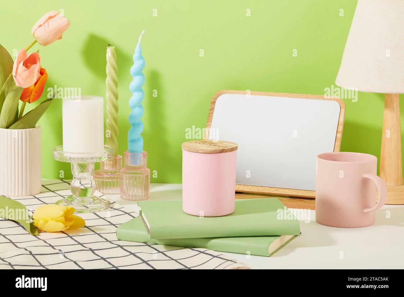 The candles are placed on glass candlesticks and a jar of scented