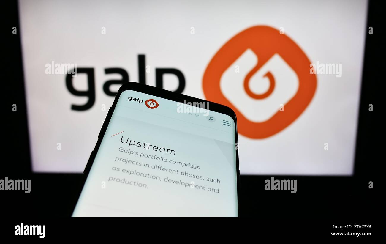 Smartphone with website of Portuguese energy company Galp Energia SGPS S.A. in front of business logo. Focus on top-left of phone display. Stock Photo