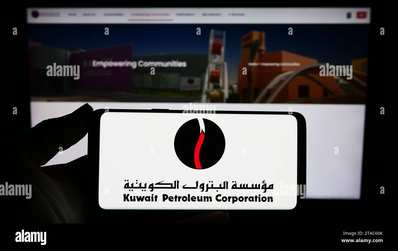 Person holding smartphone with logo of Kuwaiti oil company Kuwait