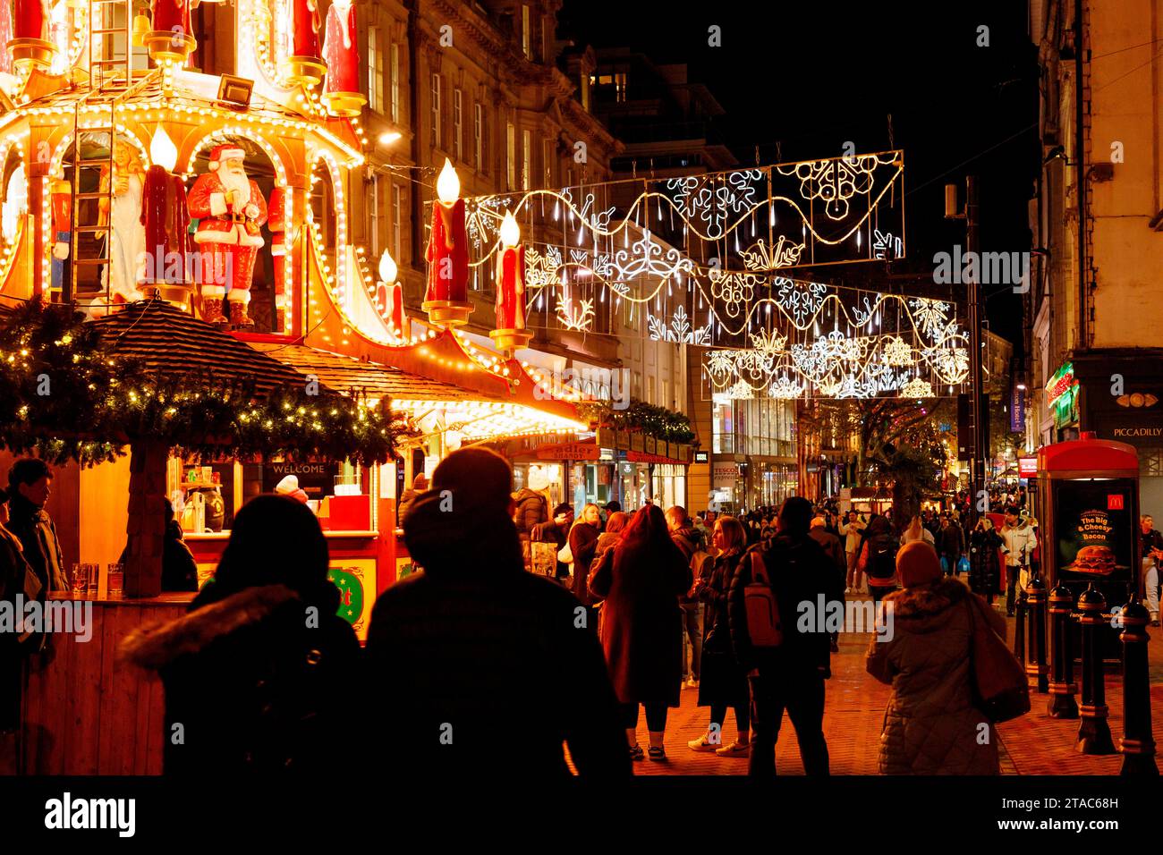 The view along New Street during Birmingham Frankfurt Christmas Market. The largest authentic German Christmas market outside of Germany or Austria. This year saw the iconic City Centre fountain 'Floozie in the Jacuzzi' bathed in red and green light joining other attractions welcoming the thousands of visitors from all over the world. Over 100 stalls lined the main streets in the City Centre and the market will be open until Christmas Eve.  Birmingham's Frankfurt Christmas Market offers a large range of traditional goods and gifts and a selection of tempting food and drink. Stock Photo