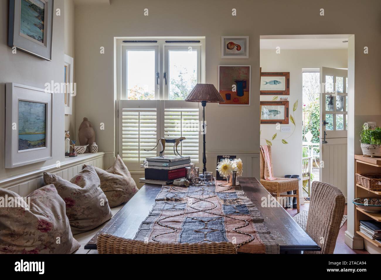 West African Kuba cloth on table in dining area of colonial style single-storey home. Truro, Cornwall, UK. Stock Photo