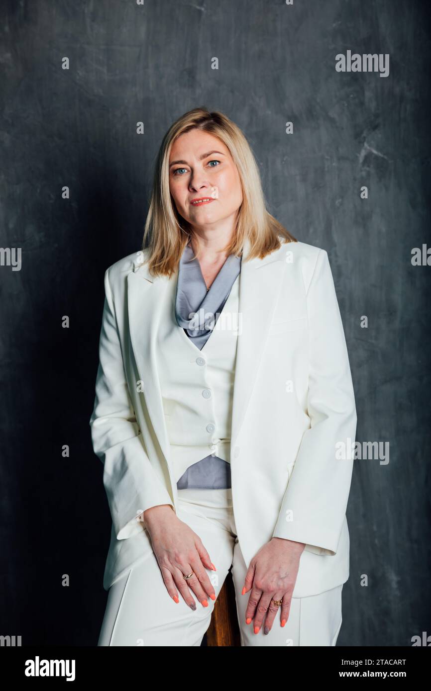 adult woman in white business suit in office Stock Photo - Alamy