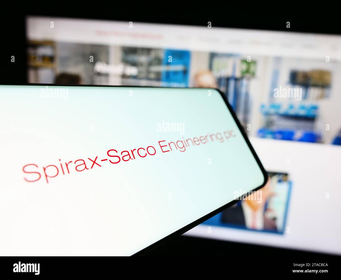 Mobile phone with logo of British company Spirax-Sarco Engineering plc in front of business website. Focus on center-left of phone display. Stock Photo