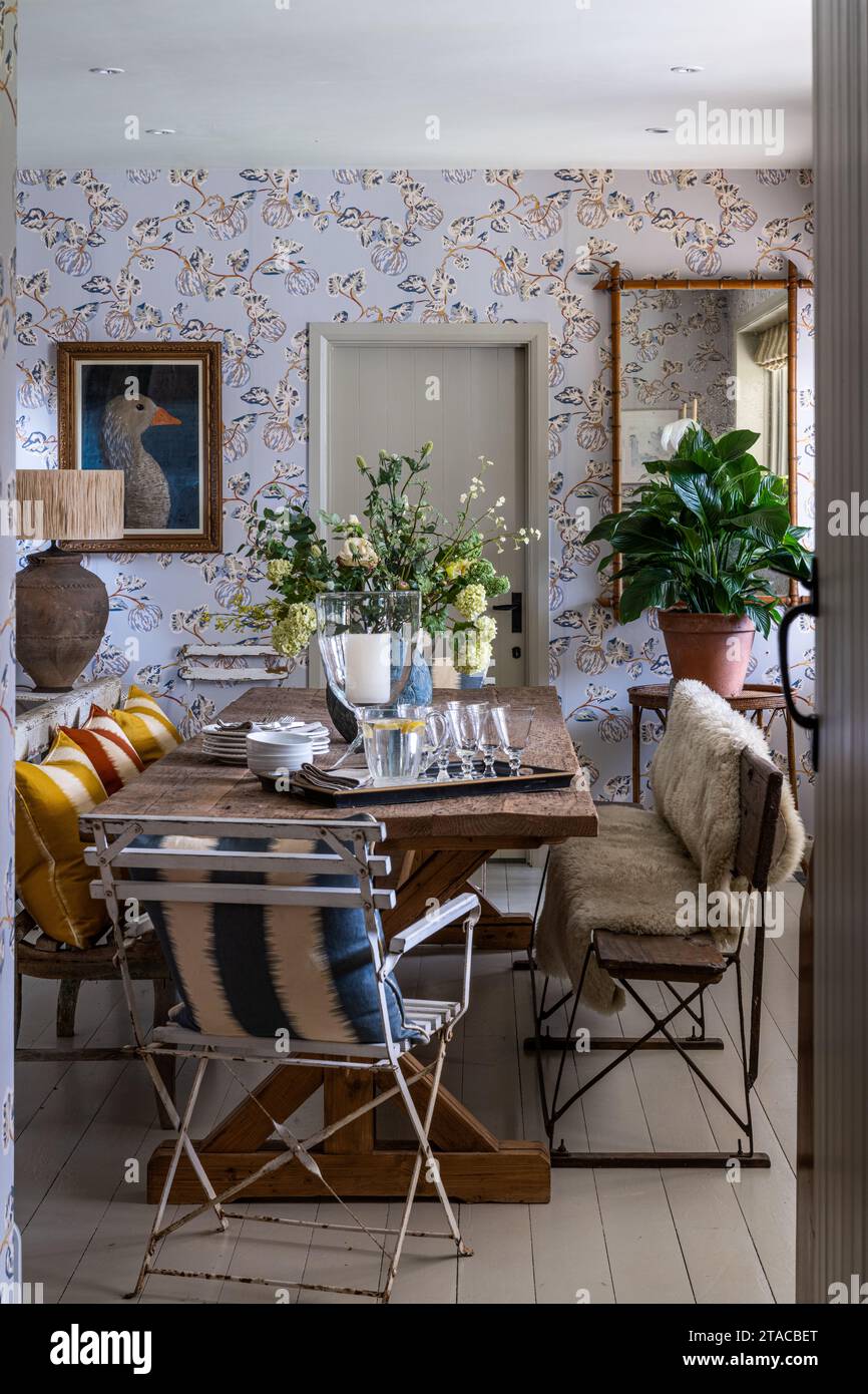 Locally sourced furniture with Pumpkin wallpaper by Eloise Home in 1930s Arts and Crafts style home. Hove, East Sussex, UK. Stock Photo