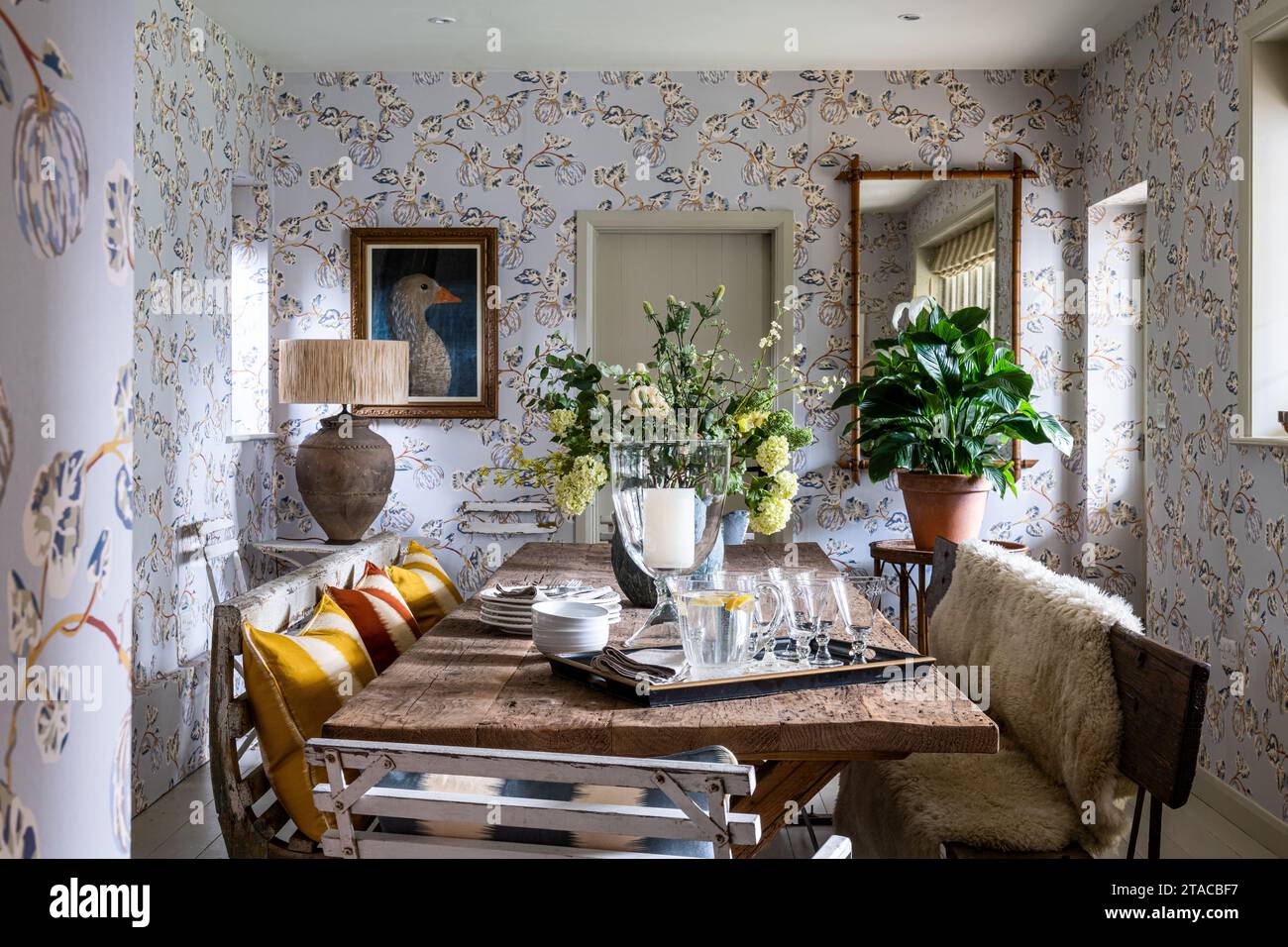 Locally sourced furniture with Pumpkin wallpaper by Eloise Home in 1930s Arts and Crafts style home. Hove, East Sussex, UK. Stock Photo