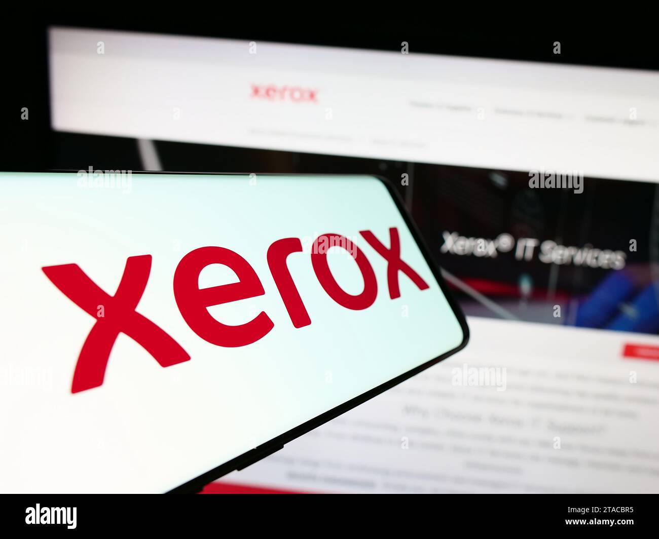 Mobile phone with logo of American printer company Xerox Holdings Corporation in front of business website. Focus on center of phone display. Stock Photo