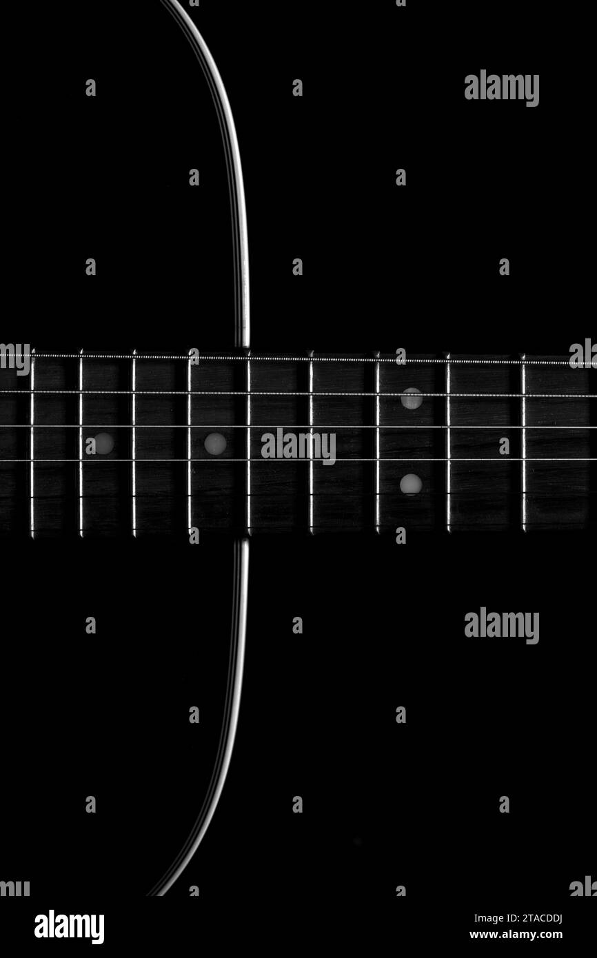 A closeup shot of details on a glossy black acoustic guitar Stock Photo