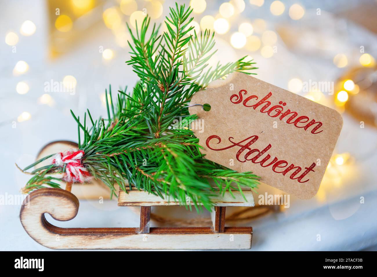 November 30, 2023: Beautiful Advent greeting lettering on a sign on a rustic wooden sleigh. Christmas decoration FOTOMONTAGE *** Schönen Advent Gruß Schriftzug auf einem Schild an einem rustikalen Holzschlitten. Weihnachtsdekoration FOTOMONTAGE Stock Photo