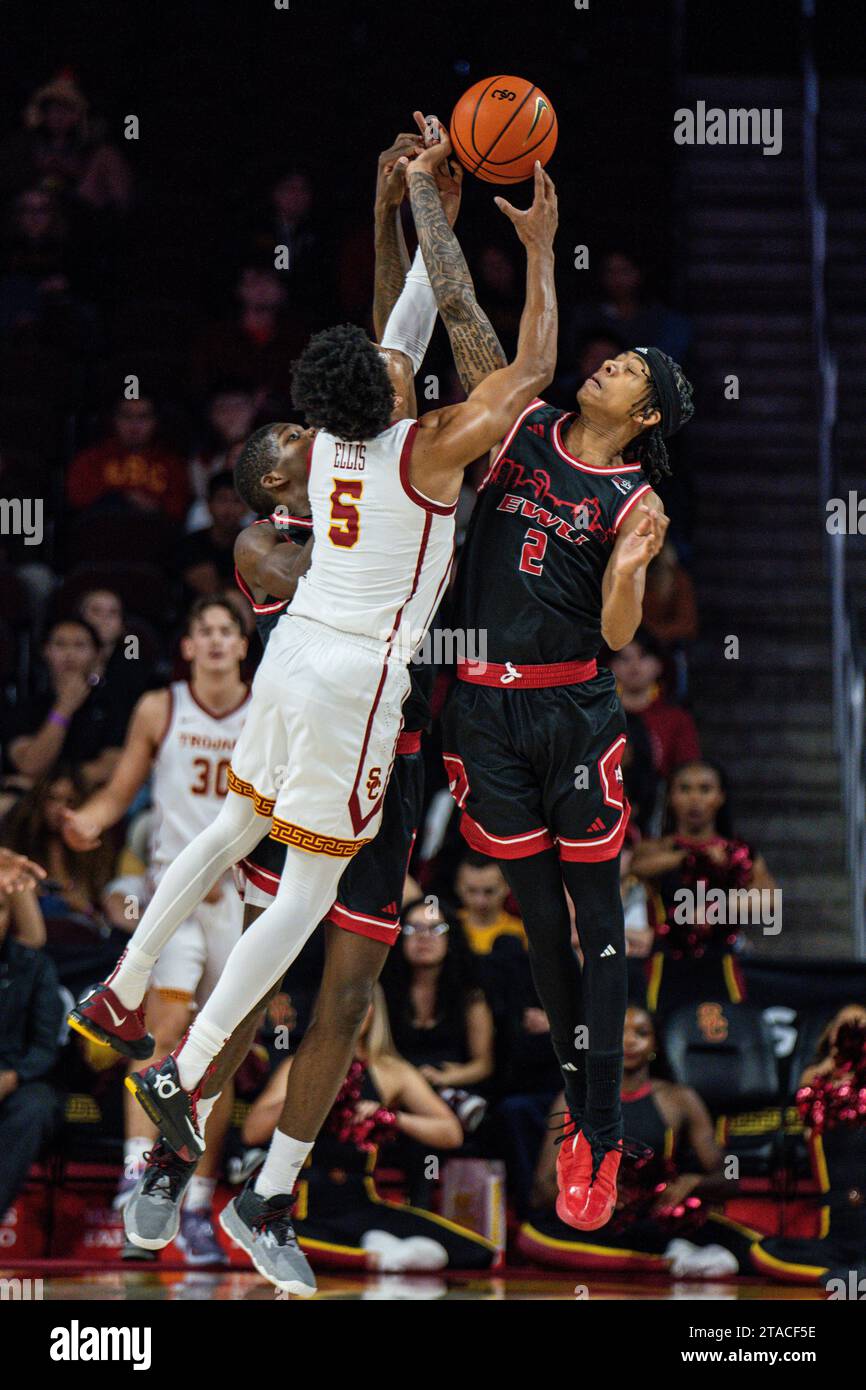 USC Trojans guard Boogie Ellis (5) and Eastern Washington Eagles guard Mason Williams (2) fight for possession during a NCAA men’s basketball game, We Stock Photo