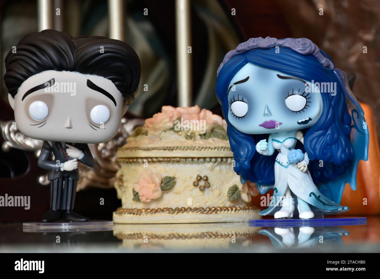 Funko Pop action figures of Emily and Victor from dark fantasy gothic animated film Corpse Bride. Vintage cage,wedding cake, romantic, gloomy. Stock Photo