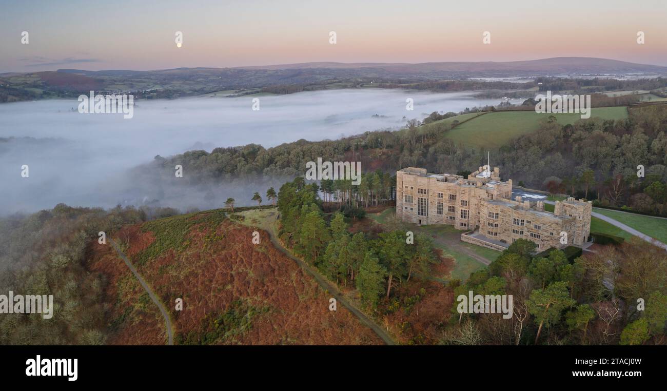 Aerial view of Castle Drogo at dawn on a misty winter morning, Dartmoor National Park, Devon, England.  Winter (March) 2022. Stock Photo