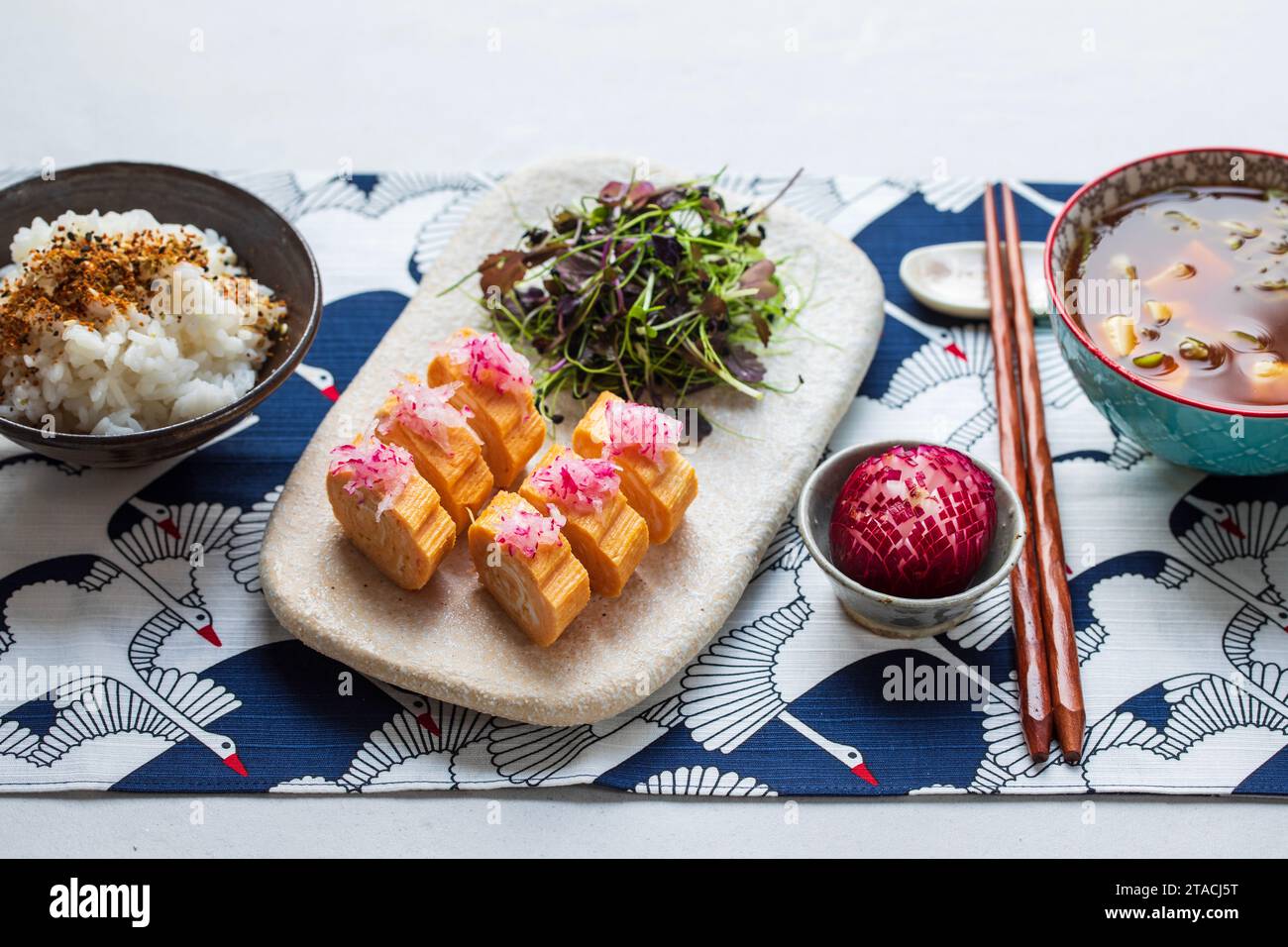 Japanese breakfast egg roll tamagoyaki, miso soup, herb salad and rice