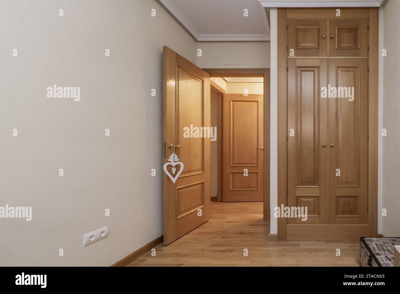 Built-in wardrobe in the bedroom with oak wood doors Stock Photo