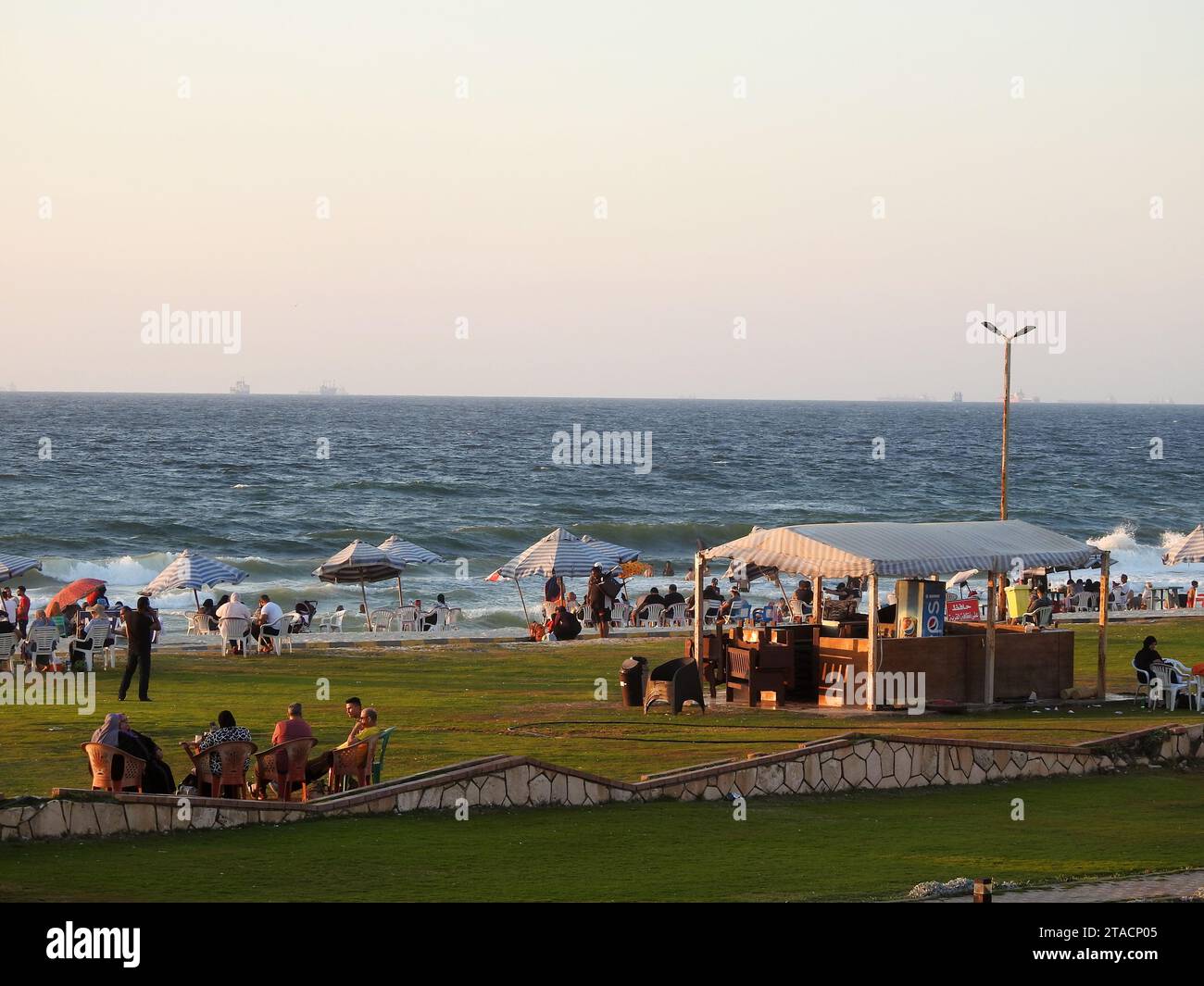 Alexandria, Egypt, September 9 2022: Alexandria beach, with people on the shore having fun and enjoying their holiday summertime, with the Mediterrane Stock Photo