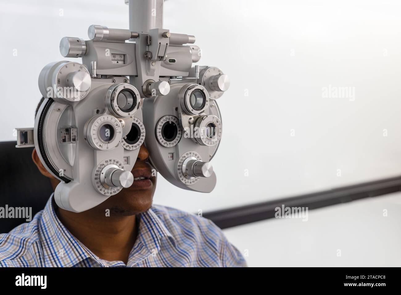 african american at the optometrist having an eye test for new spectacles Stock Photo