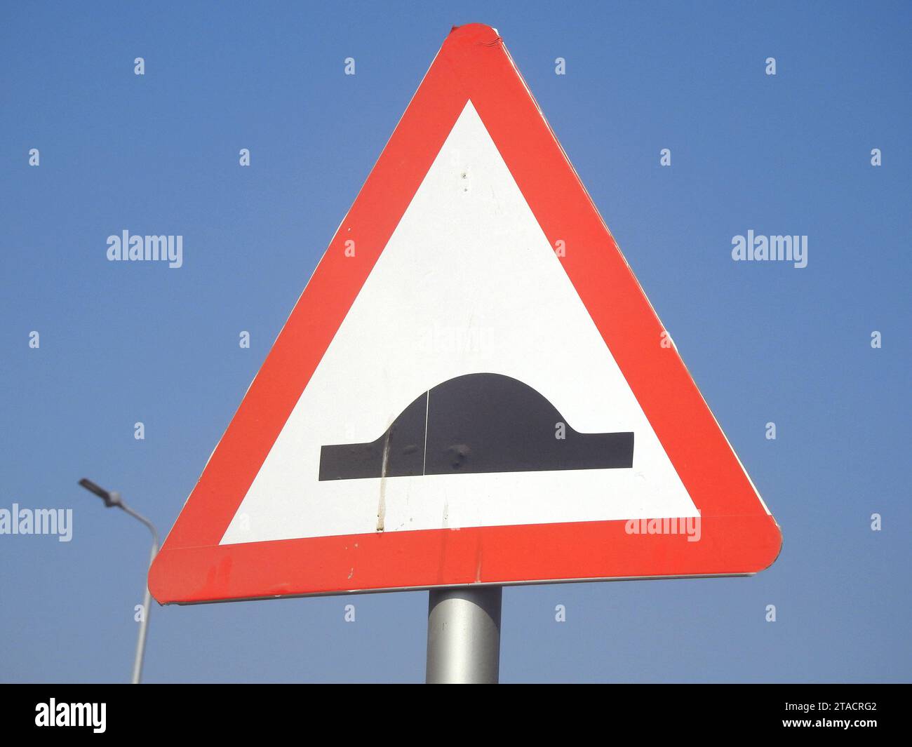 A signboard for Speed bumps ahead, to warn the drivers to be careful and slow down, traffic thresholds, breakers or sleeping policemen, a class of tra Stock Photo