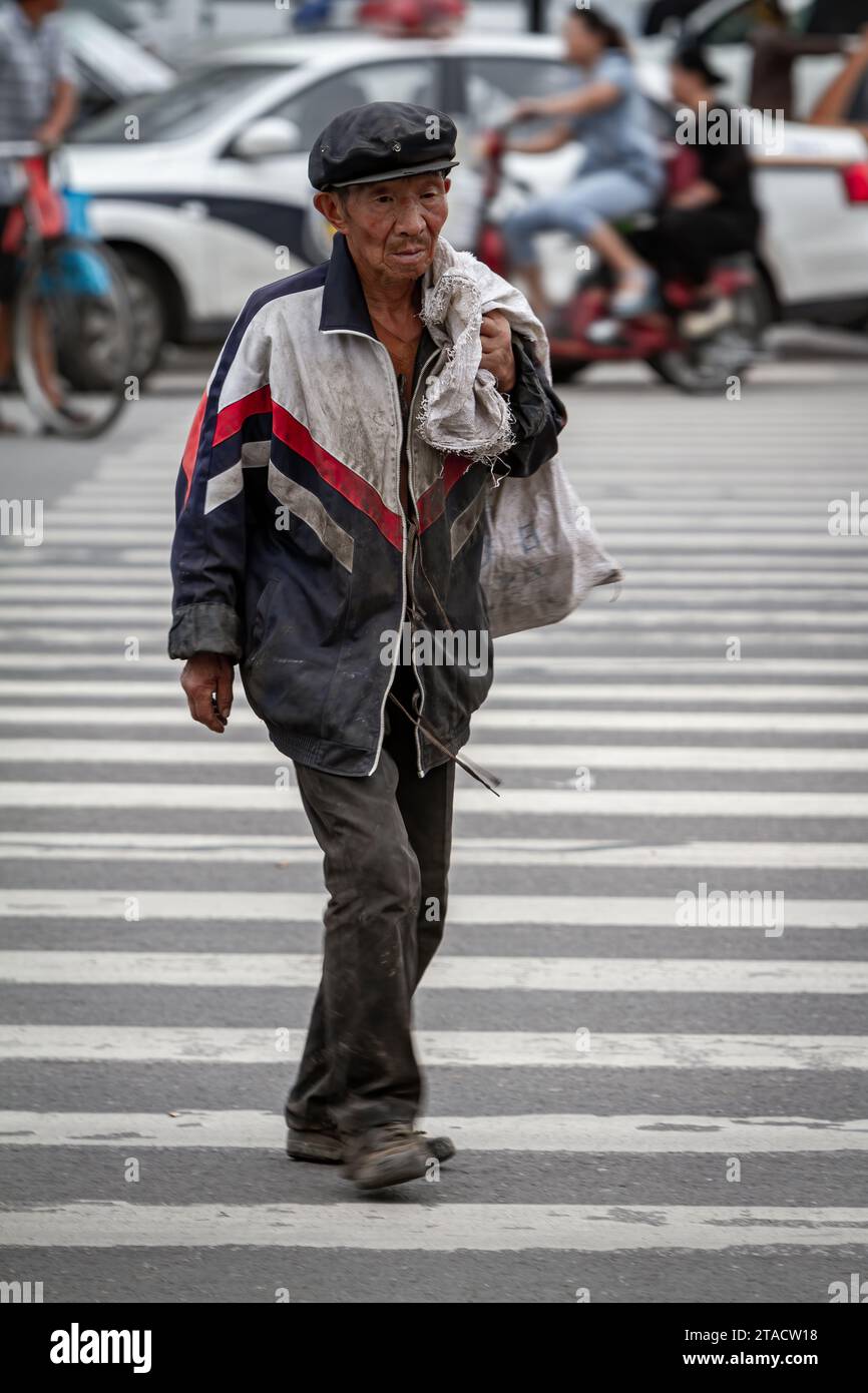 A homeless person in the streets of Xian China, August 14, 2014 Stock Photo