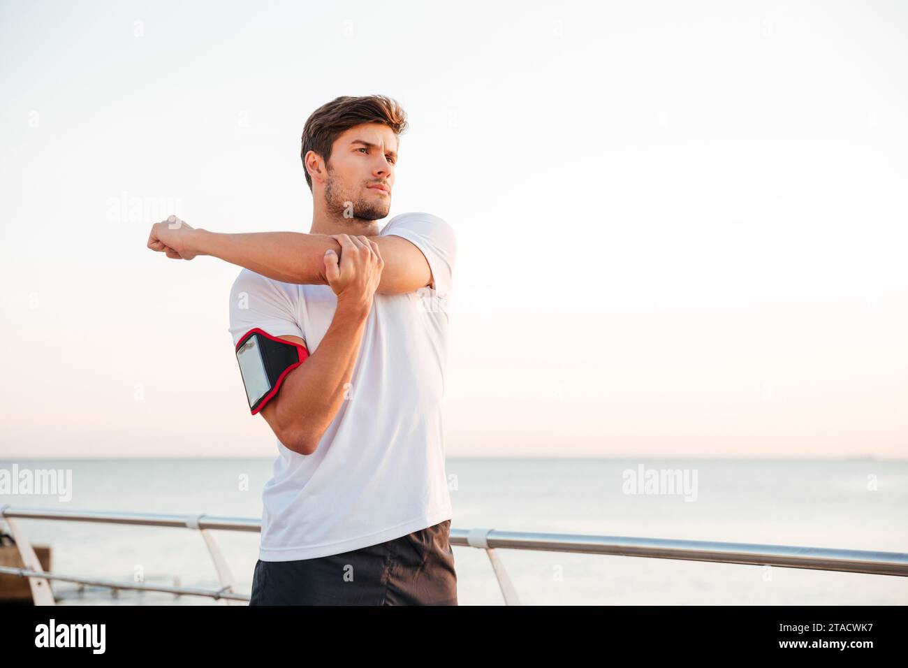 Young man in stretching arms hi-res stock photography and images - Alamy