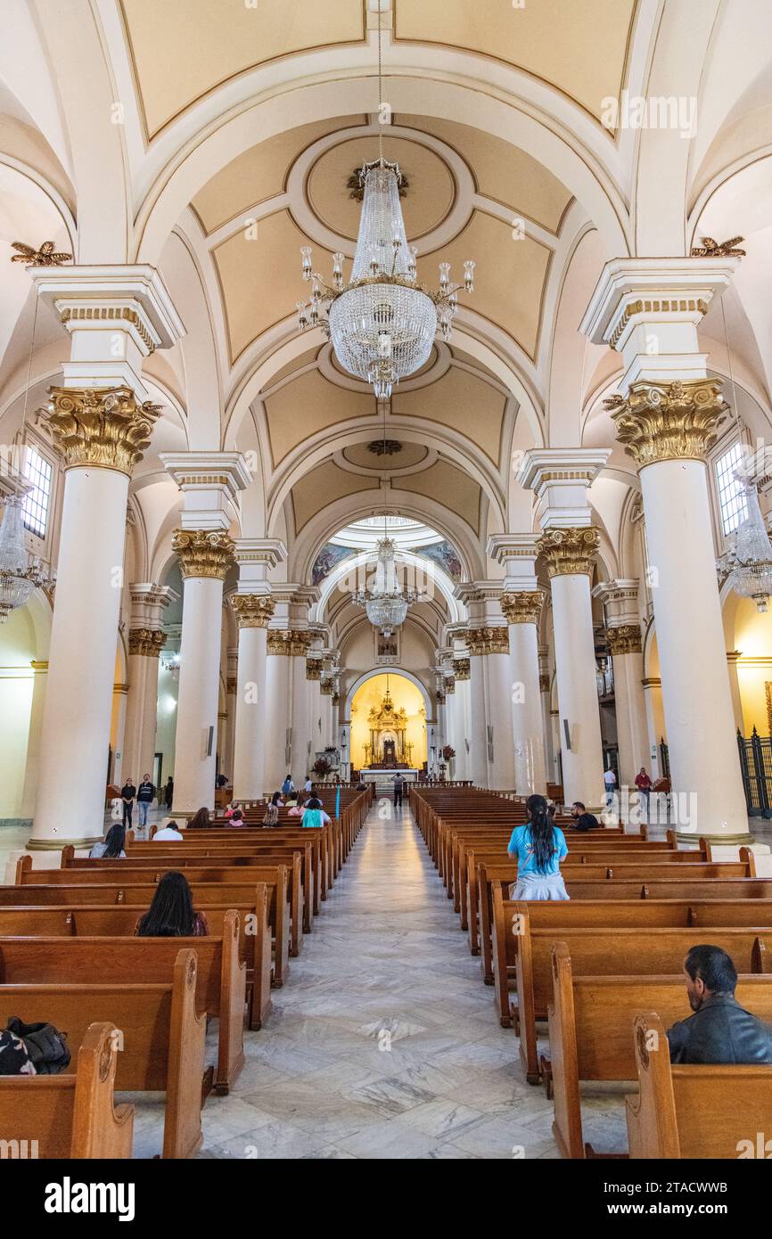 Inside Catedral Primada de Colombia with people praying, in Bogotá, Colombia Stock Photo