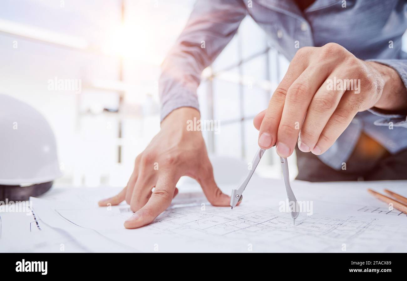 Architect working on drawing table in office Stock Photo