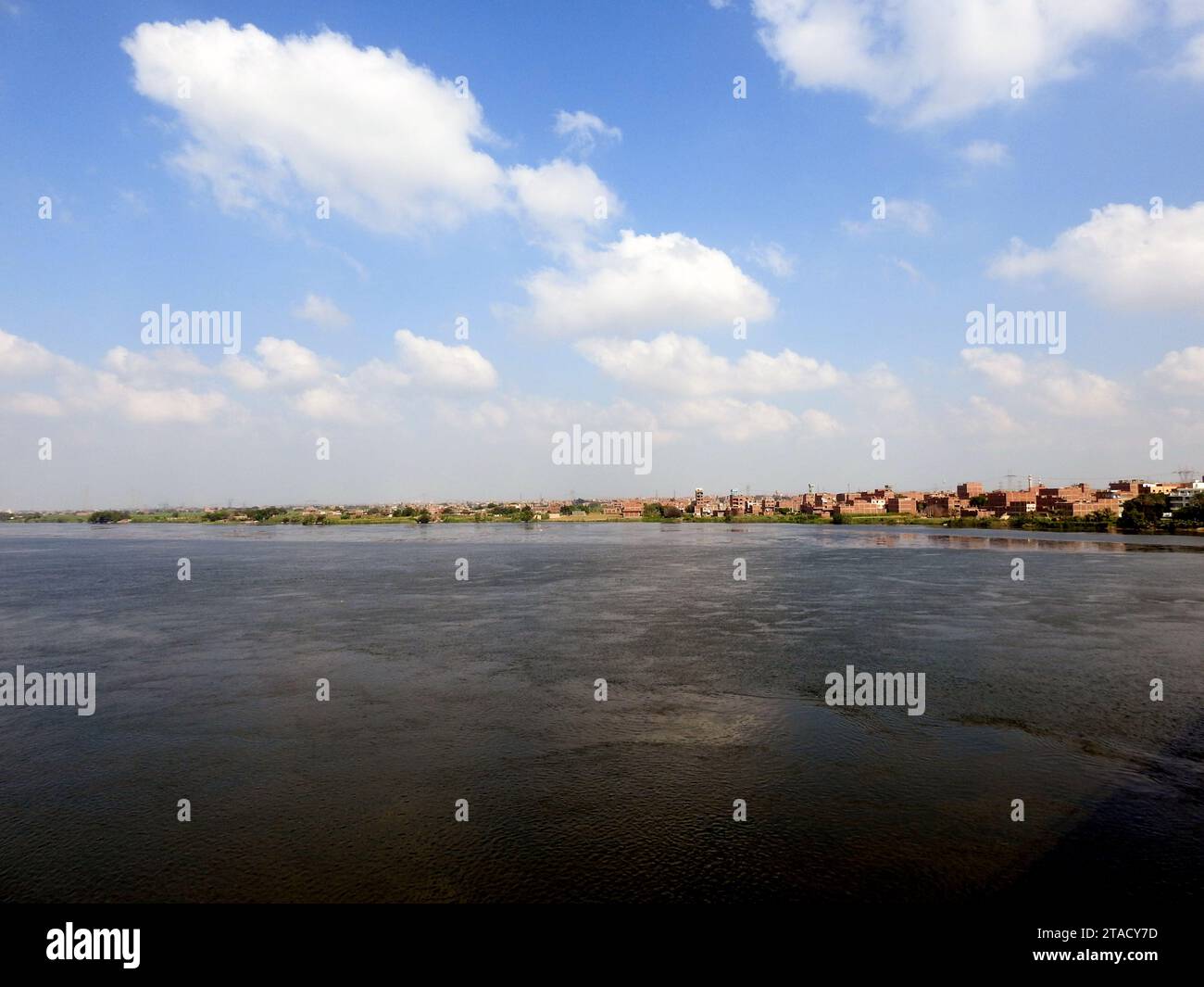 Giza, Egypt, September 9 2022: The Nile river in Egypt, with a village ...
