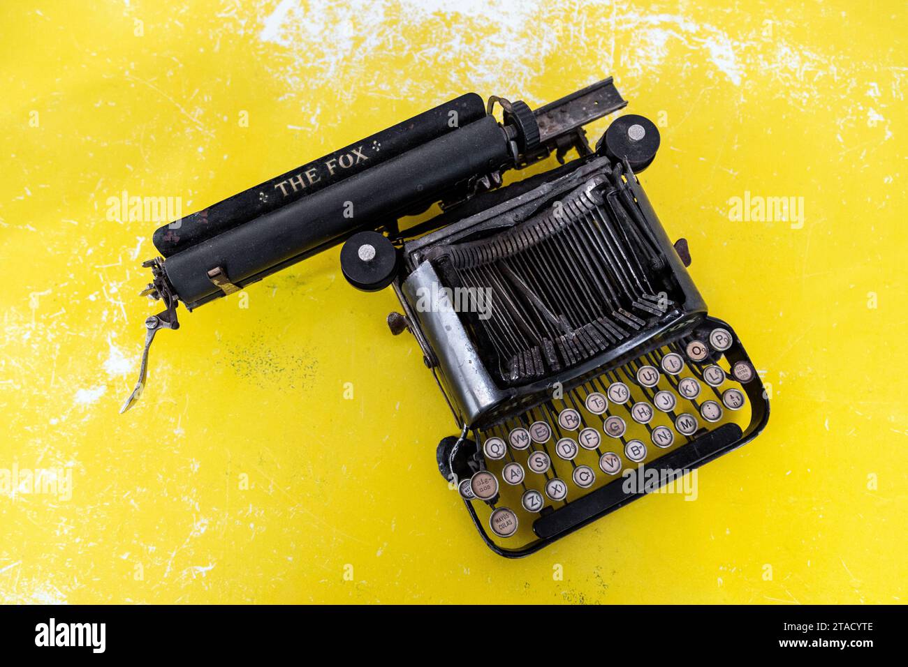 The Fox vintage typewriter on yellow background Stock Photo