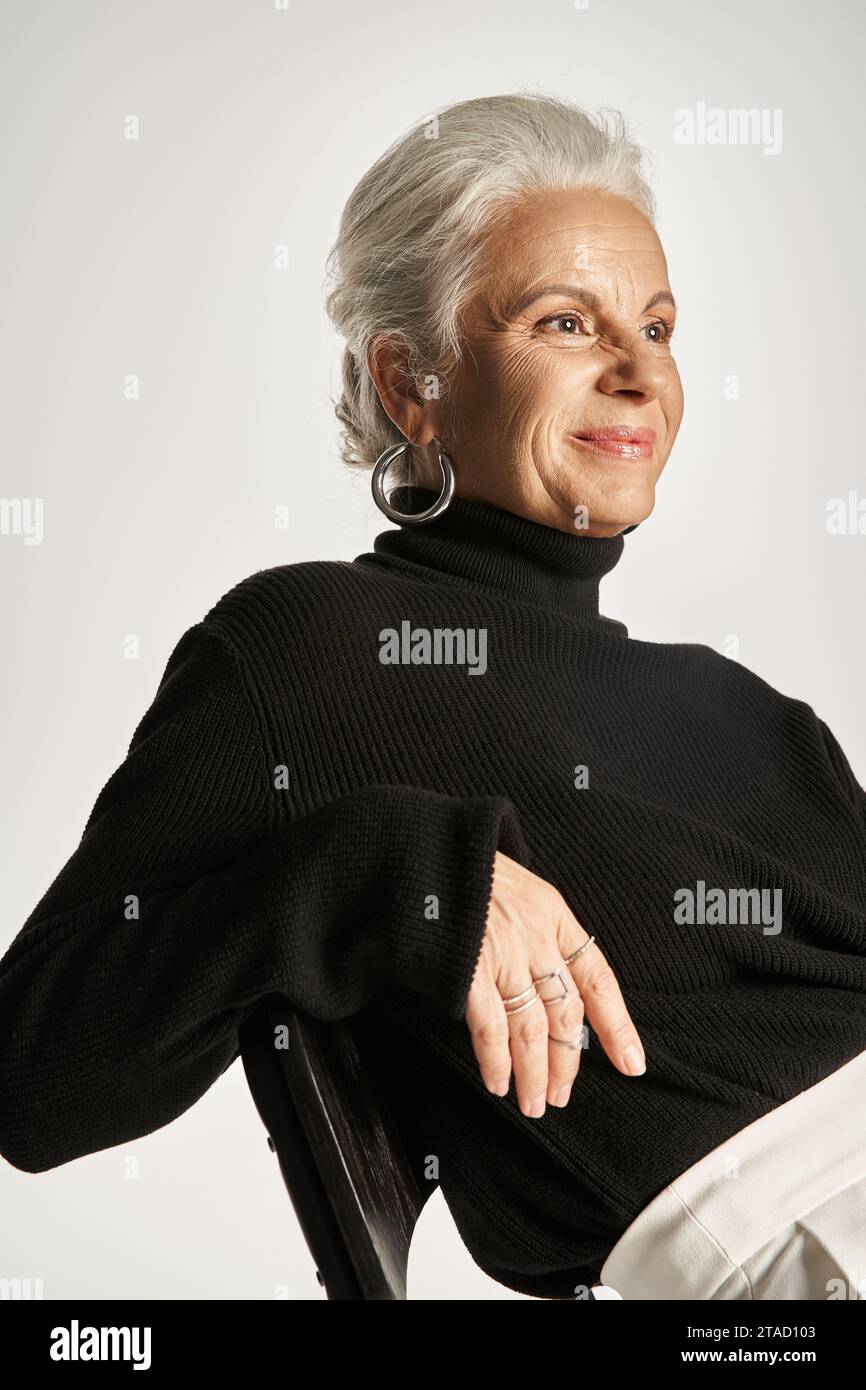 happy middle aged business woman in smart casual attire and hoop