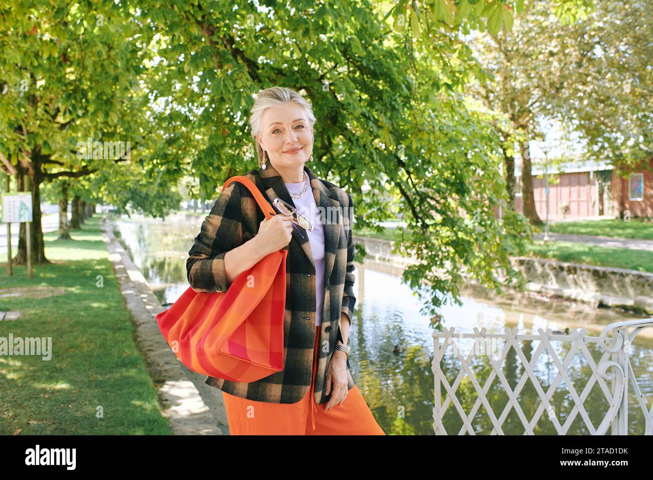 Outdoor portrait of beautiful and elegant middle age 55 - 60 year old ...