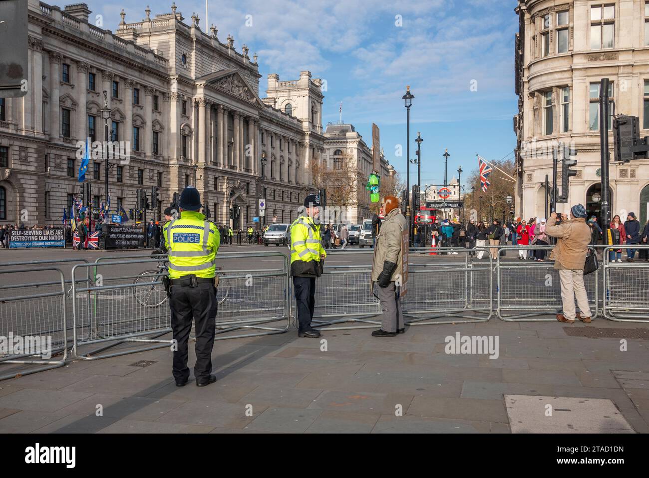 Police officers talking to a protestor in Westminster, London Stock Photo