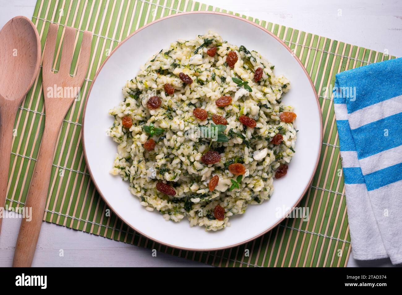 Rice with spinach and raisins. vegan recipe. Stock Photo