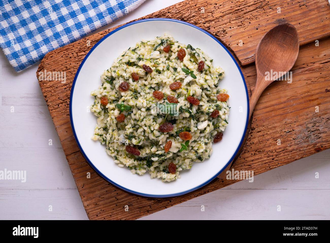 Rice with spinach and raisins. vegan recipe. Stock Photo