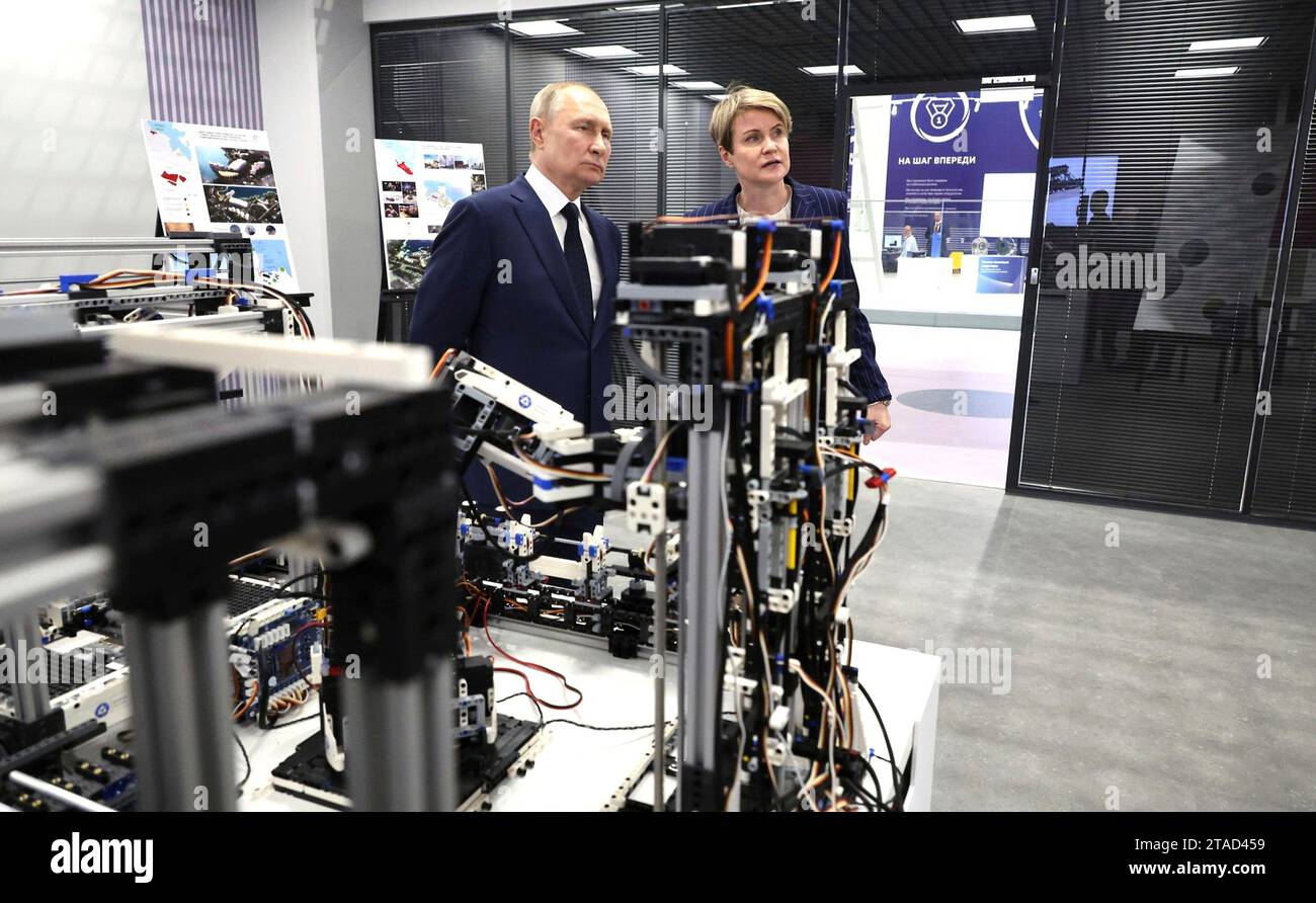 Sochi, Russia. 29th Nov, 2023. Russian President Vladimir Putin, left, accompanied by the head of the Talent and Success Educational Foundation, Yelena Shmelyova, right, is shown a display of robotics at the Breakthrough-Sirius robotics training and experimental centre, November 29, 2023 in Sochi, Russia. Credit: Mikhail Klimentyev/Kremlin Pool/Alamy Live News Stock Photo