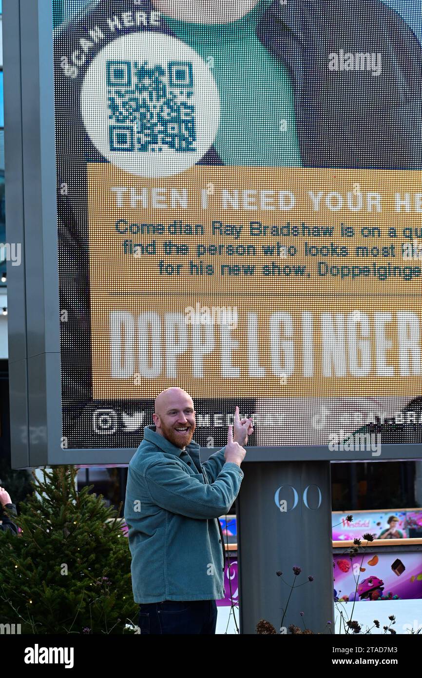 Westfield White City, London, UK. 30th Nov, 2023. Comedian Ray Bradshaw launches his worldwide search for his doppelganger. Pictured is Ray Bradshaw as he took over a billboard at Westfield White City today kicking off his search and his UK tour entitled ‘Doppelginger'. More info and tickets at raybradshaw.com. Credit: See Li/Picture Capital/Alamy Live News Stock Photo