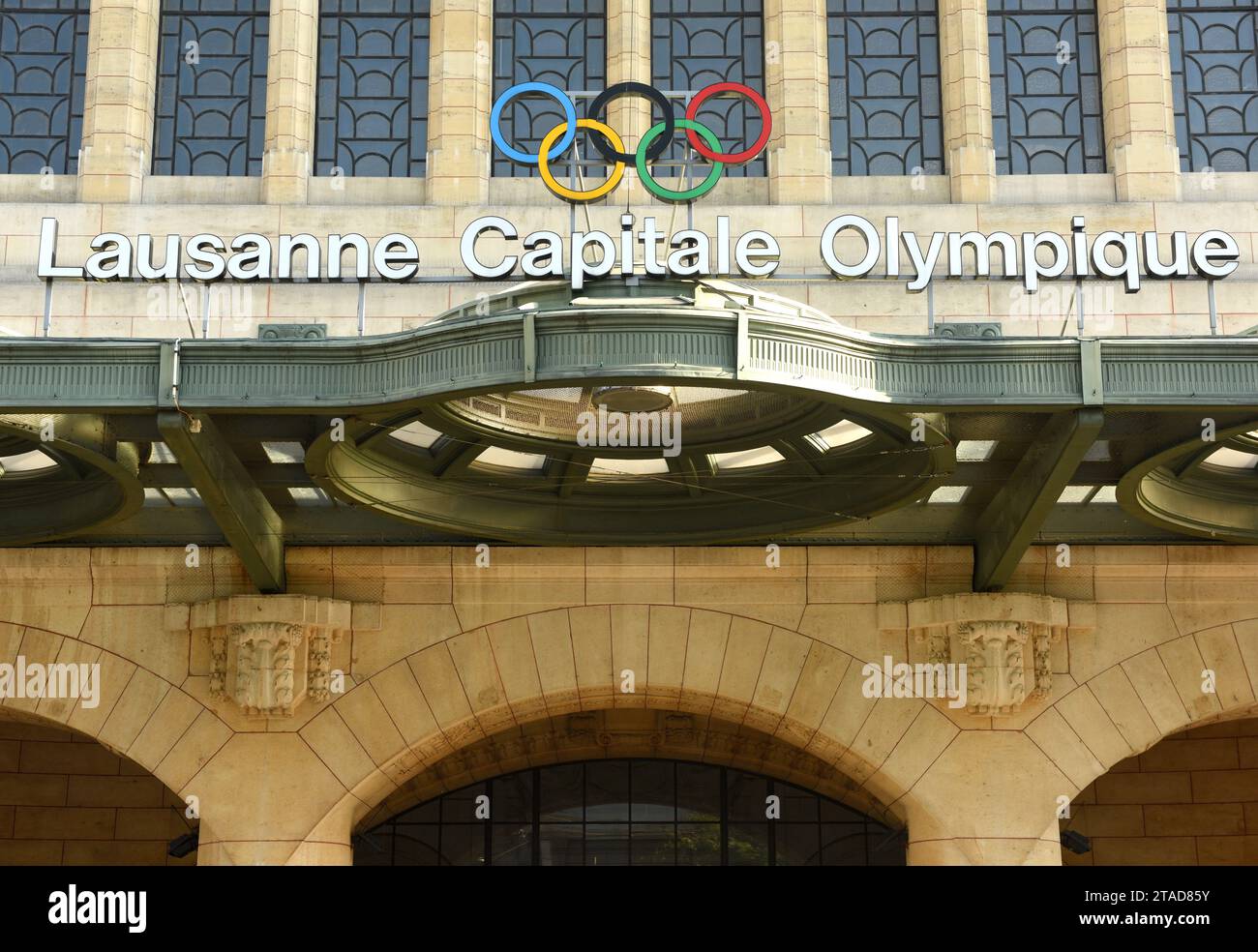 Lausanne, Switzerland -  June 03, 2017: Olympic rings and words 'Lausanne Capitale Olympique' at the main railway station building in Lausanne. Stock Photo