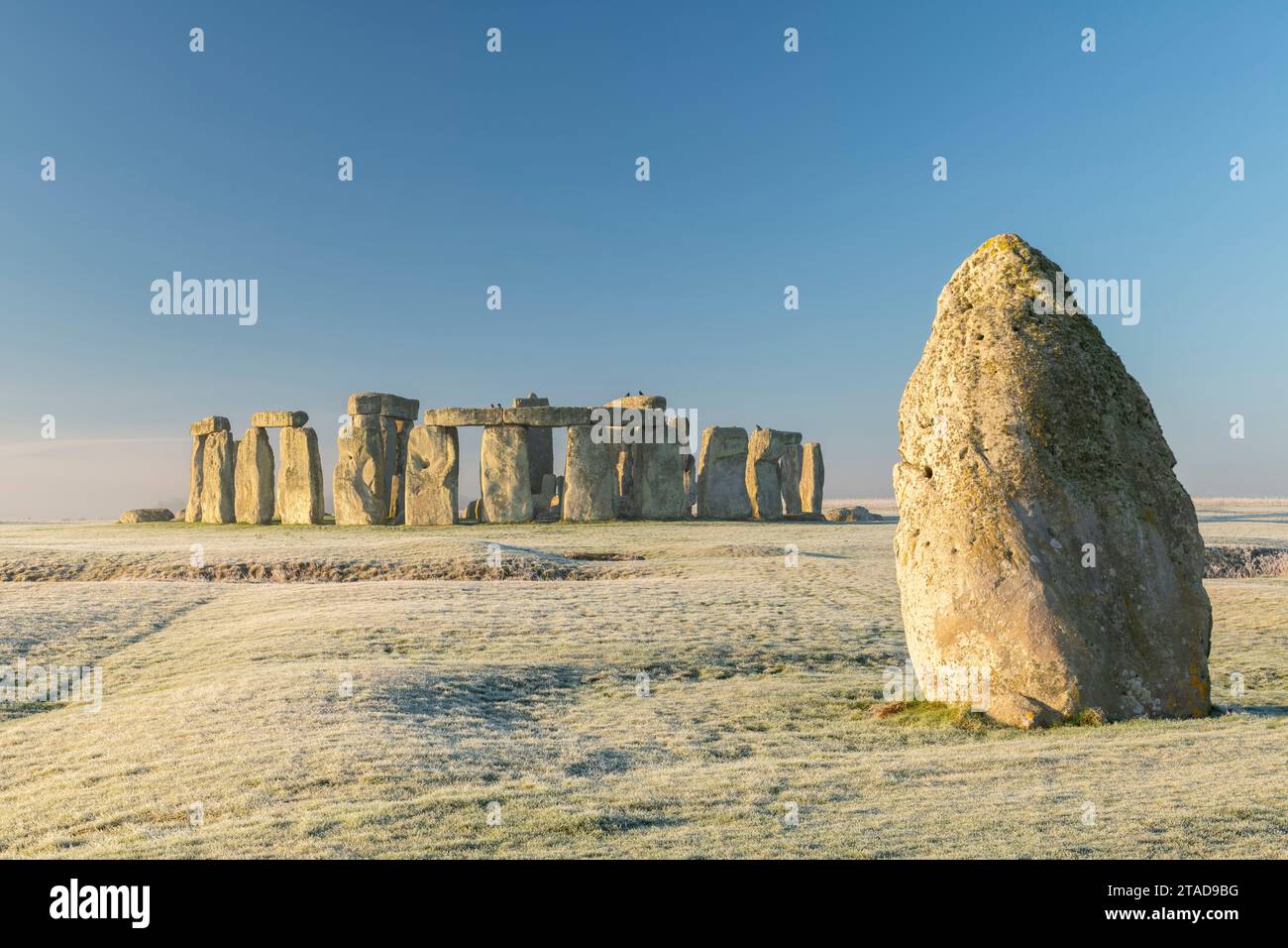 Stonehenge and the Heel Stone at dawn on a chill frosty winter morning, Wiltshire, England. Winter (January) 2022. Stock Photo