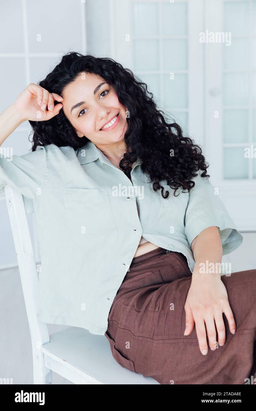 Beautiful young woman with black curly hair Stock Photo - Alamy