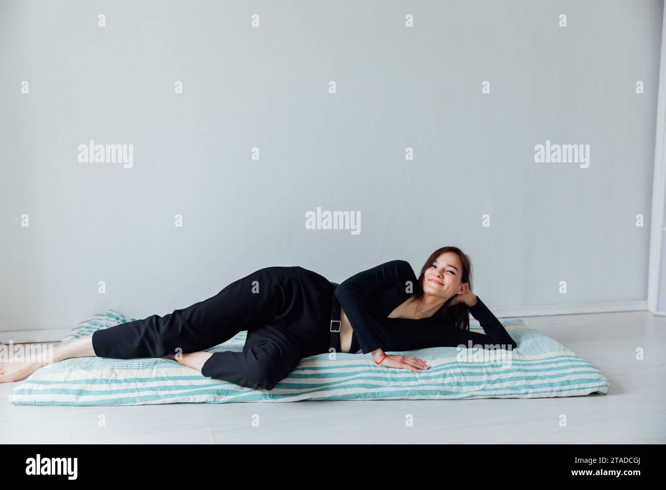 Beautiful woman lying on sleeping mattress on the floor Stock Photo Alamy
