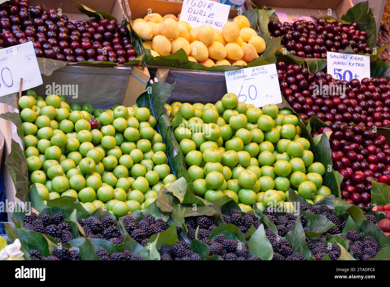 Green plums in bazaar market place Stock Photo