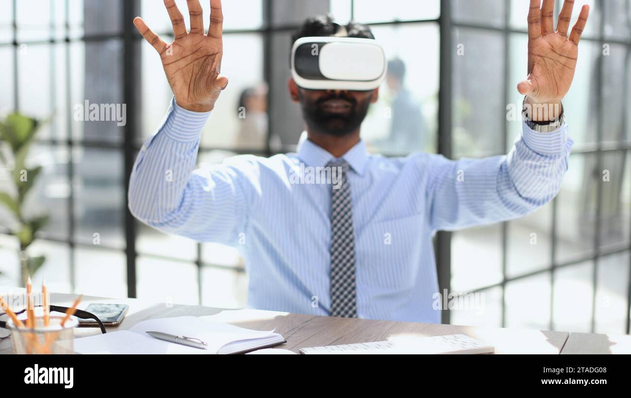 young businessman wearing virtual reality glasses in the office Stock ...