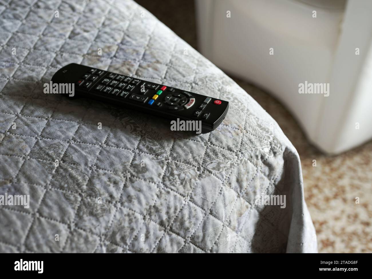 TV Remote control on bed Stock Photo Alamy