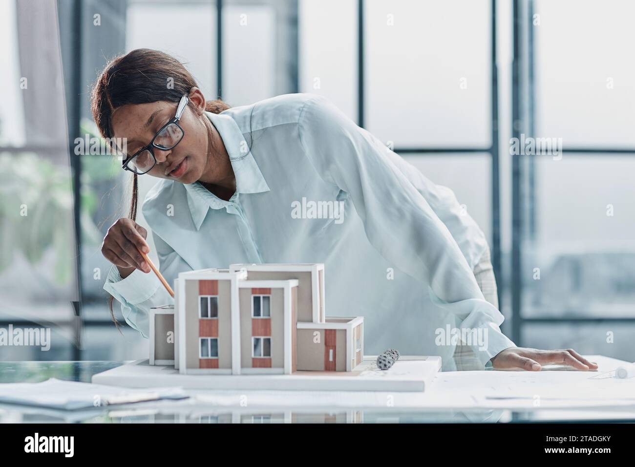 woman architect designer examines the layout of the house. new project Stock Photo