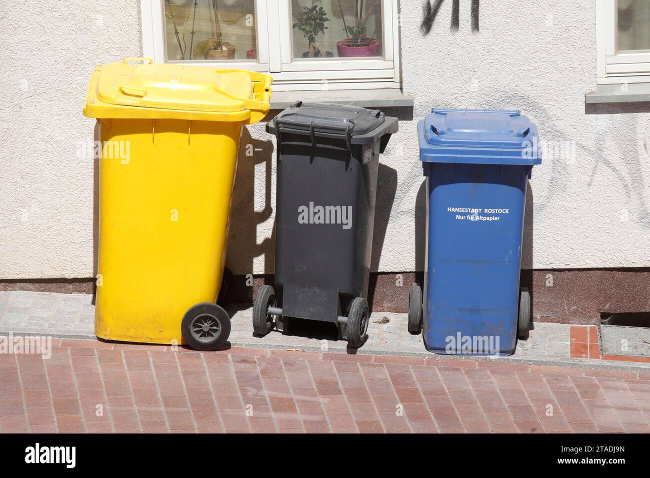 Colourful various recycling bins and waste bins, standing on the street
