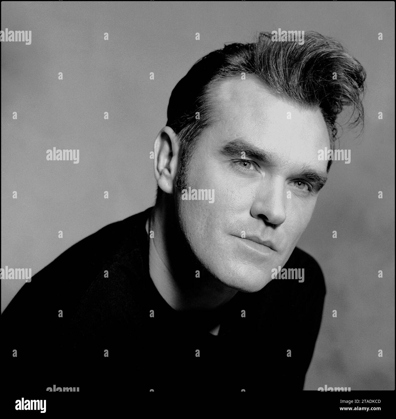 Black & white head & shoulders portrait of legendary rockstar, singer/songwriter Morrissey to promote his single “Sunny” in 1995 for Parlophone Records. It is a variation of the iconic image used by Morrissey on his Penguin Classics book cover “Autobiography”. Stock Photo