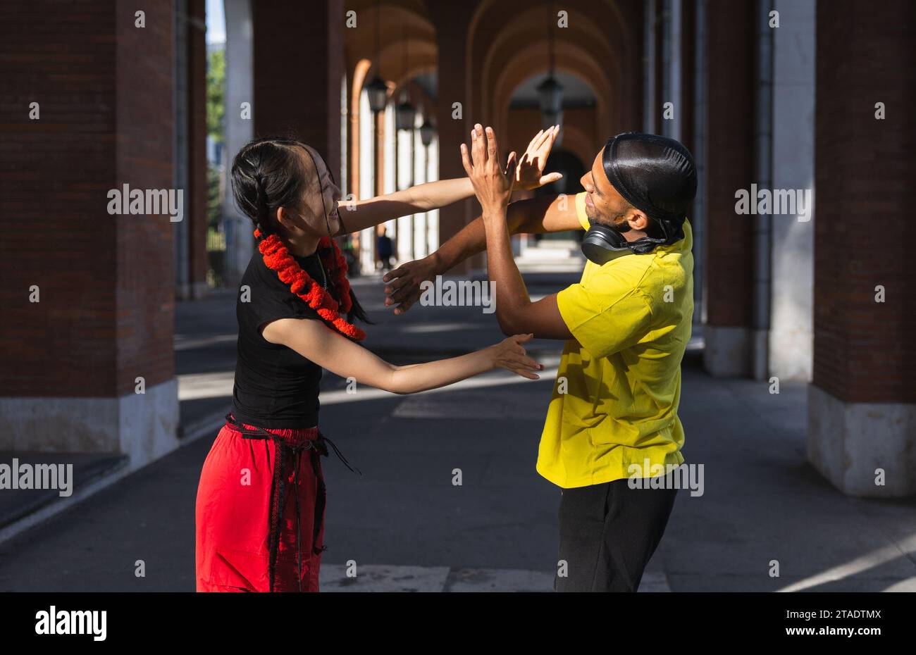 'Young couple having fun, dancing together on the street, enjoying urban dances, and being happy.' Stock Photo