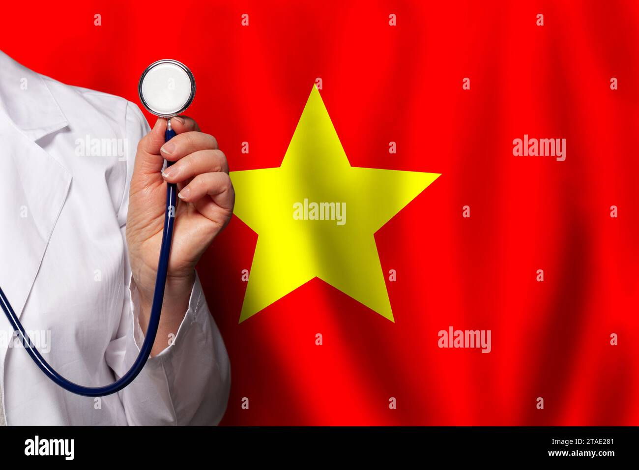 Vietnamese doctor's hand with stethoscope on the background of flag of
